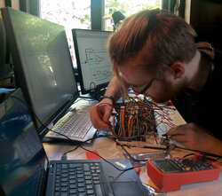 a young man screwing a circuit